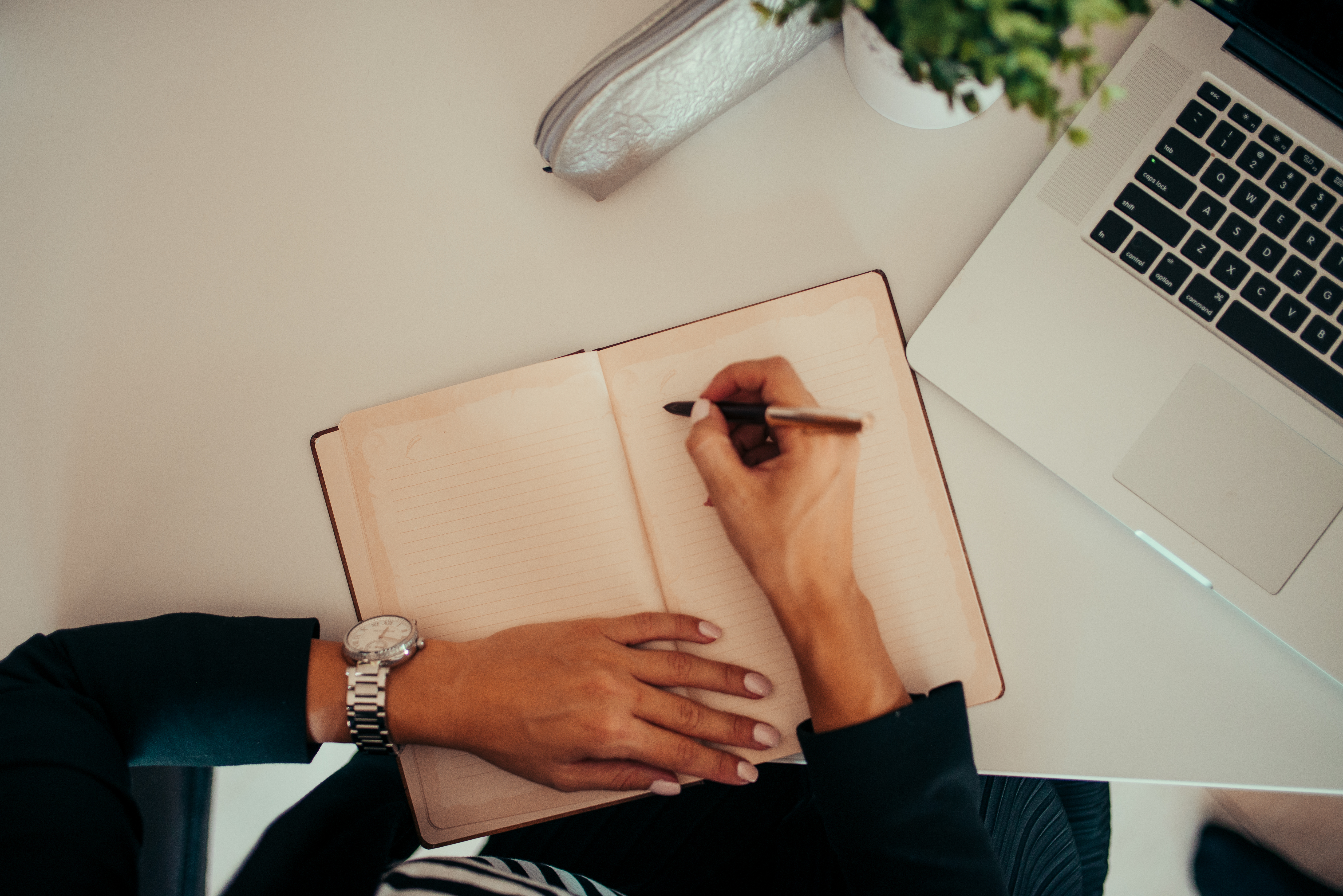 Notebook and laptop on a modern writing desk