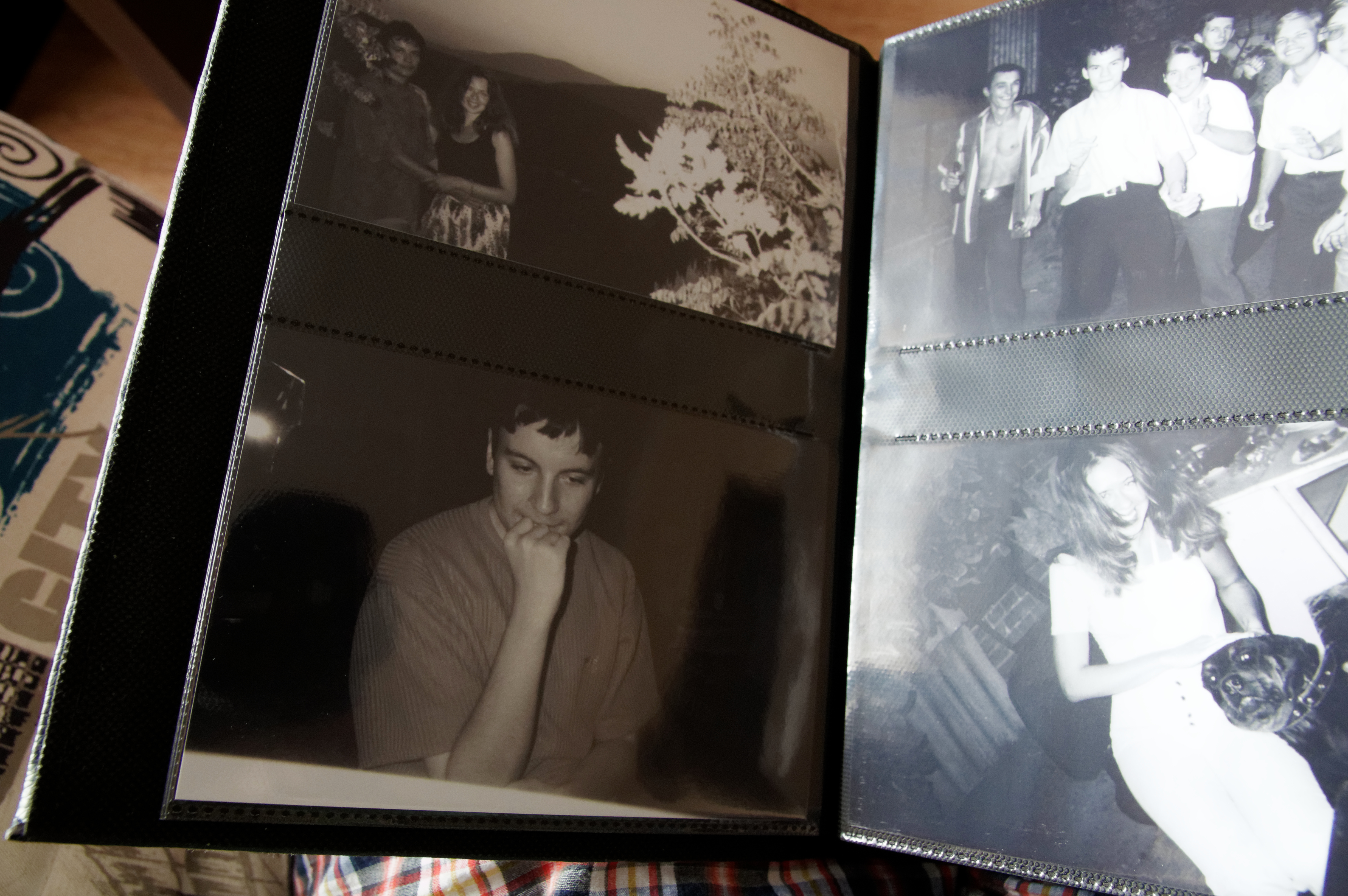 A photo album opened to black and white photographs
